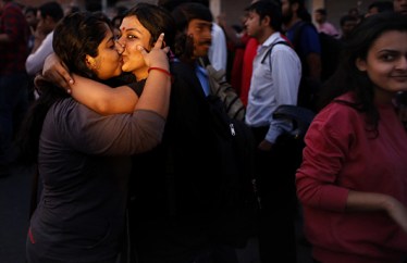 Women kiss each other to express support to the 'Kiss of Love’ campaign near the Hindu right-wing Rashtriya Swayamsevak Sangh (RSS) headquarters in New Delhi, India, Saturday, Nov. 8, 2014. The campaign was launched to protest alleged moral policing by Hindu right-wing organizations in India. (AP)