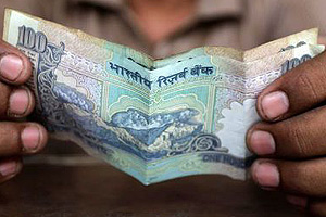 Indian rupee slips past psychological $63 mark to hit 13-month low