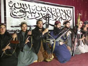 Militants, who the Pakistan Taliban say attacked the Army Public School in Pehawar on Tuesday, pose with weapons and Khalifa Omar Mansoor Hafzullah (C, in blue) at an unknown location in this undated handout picture released on December 17, 2014. (Reuters)