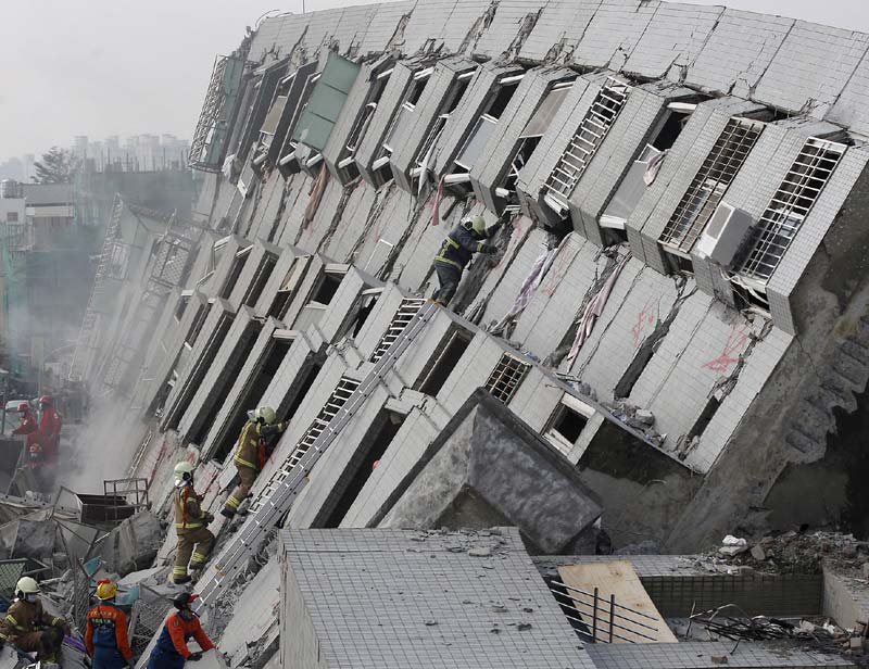 Earthquake in Taiwan: The quake came two days before the start of Lunar New Year celebrations that mark the most important family holiday in the Chinese calendar. The building had 256 registered residents, but far more people could have been inside when it fell because the population might have swelled ahead of the holiday, when families typically host guests.<br>Image Caption: Rescue personnel work at the site where a 17-storey apartment building collapsed during an earthquake in Tainan, southern Taiwan (Reuters)</br>