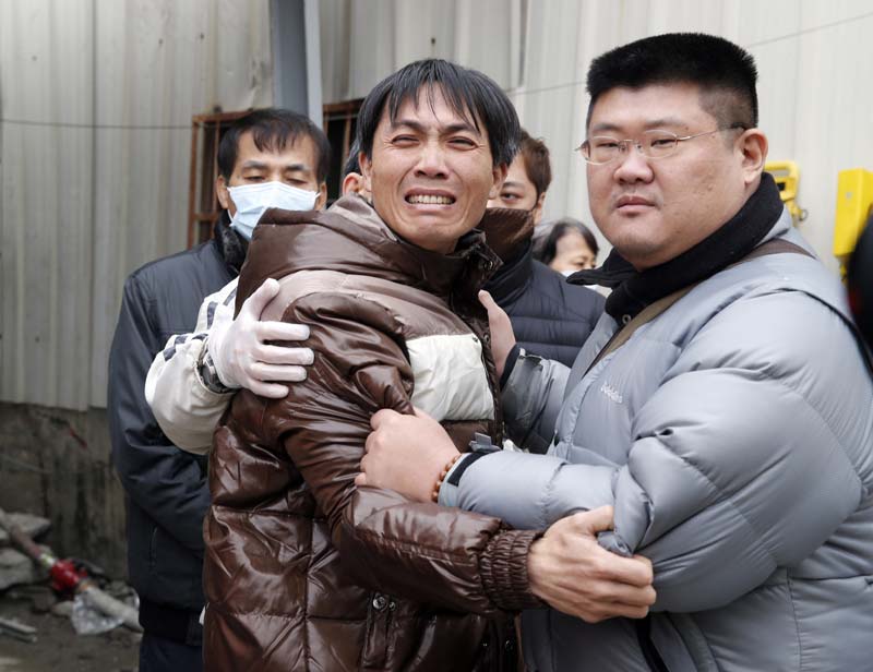 Earthquake in Taiwan: Nearly 340 people were rescued from the rubble in Tainan, the city hit worst by the quake. About 2,000 firefighters and soldiers scrambled with ladders, cranes and other equipment to the ruins of the 17-floor residential building, which folded like an accordion onto its side after the quake struck. The quake was felt as a lengthy, rolling shake in the capital, Taipei, on the other side of the island. But Taipei was quiet, with no sense of emergency or obvious damage just before dawn. <br>Image Caption: A man breaks down after seeing the body of a relative recovered from a collapsed building in Tainan, Taiwan. A 6.4-magnitude earthquake struck southern Taiwan early Saturday, toppling at least one high-rise residential building and trapping people inside. (AP)</br>