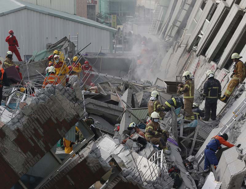 Earthquake in Taiwan: People with their arms around firefighters were being helped from the building, and cranes were being used to search darkened parts of the structure for survivors. Men in camouflage, apparently military personnel, marched into one area of collapse carrying large shovels. <br>Image Caption: A site where buildings collapsed is seen in this aerial picture taken after a powerful earthquake hit Tainan, southern Taiwan (Reuters)</br>
