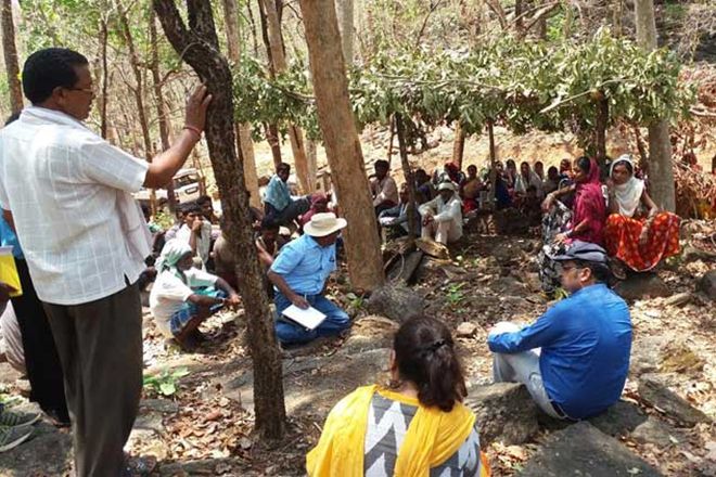 Officials addressing the villagers near the digging site