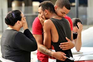 Friends and family members embrace outside the Orlando Police Headquarters during the investigation of a shooting at the Pulse night club in Orlando, Florida. (Reuters)