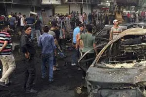Baghdad : Iraqi security forces and civilians gather at the site after a car bomb at a commercial area in Karada neighborhood, Baghdad. (AP/PTI)