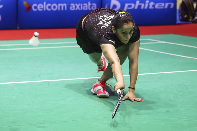 Saina Nehwal returns a shot to Thailand 's Pornpawee Chochuwong during the Malaysia Masters badminton tournament women's singles final match in Sibu, Malaysia. (AP)