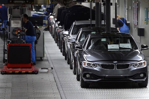 Employees of German car maker BMW work on an assembly line for BMW cars at the company's plant in Munich, southern Germany, on March 18, 2014. German top-of-the-range car maker BMW, who said on March 13, 2014 it achieved record sales and earnings and plans to pay an increased dividend to shareholders, will have its annual press conference on March 19, 2014. AFP PHOTO / CHRISTOF STACHE (Photo credit should read CHRISTOF STACHE/AFP/Getty Images)