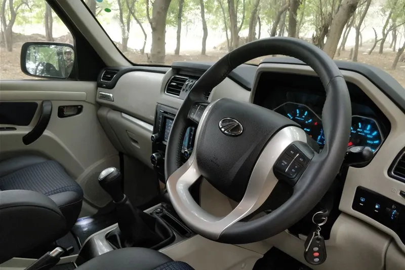 On the inside, the new Mahindra Scorpio gets faux leather seats, faux leather wrapped steering and gear lever, new roof mounted sunglass holder and enhanced storage spaces. It also features a reverse parking camera with dynamic assist, new one-touch lane change indicator and new auto window roll-up. Safety is covered by dual front airbags, anti-lock braking system (ABS), collapsible steering column & side intrusion beams, panic brake indication, engine immobiliser, panic brake indicator, anti-theft warning, speed alert, among others.