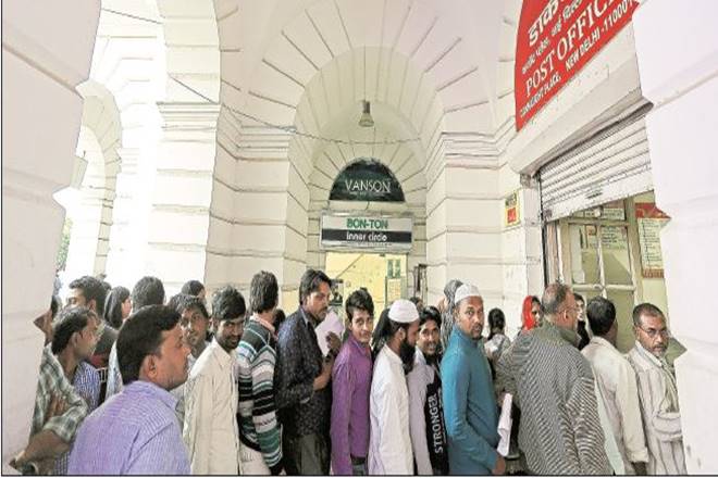 People queue to enter a post office in Connaught Place in New Delhi. (Bloomberg)