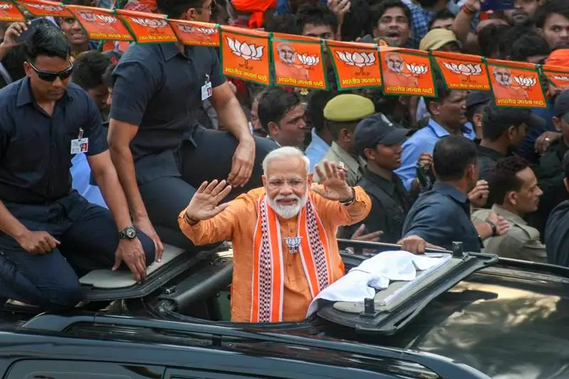 Prime Minister Narendra Modi on Thursday undertook a mega roadshow at his parliamentary constituency in Varanasi, Uttar Pradesh. The road show was held a day before PM Modi is slated to file his nomination papers. Wearing a saffron kurta and scarf, PM Modi's road show was cheered by a huge crowd as he passed through the Lanka and Assi areas of the temple town. (PTI Photo)