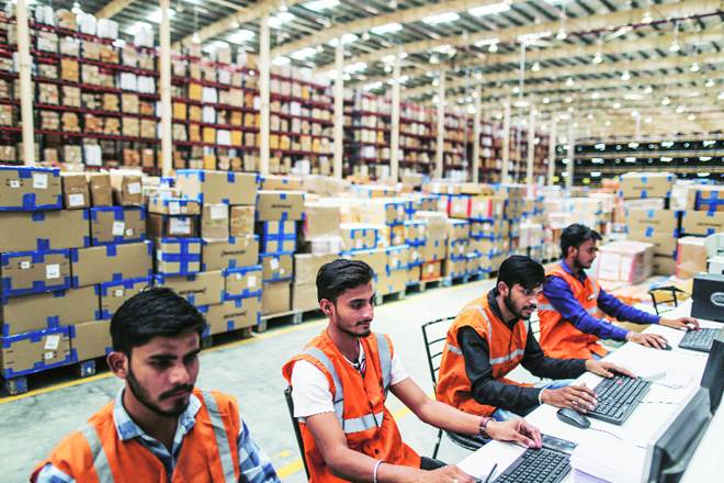 Workers at a Future Group warehouse in Nagpur. The conglomerate, the author says, allows managers to look at different ways of enhancing sales based on their own experience or intuition without having to get the nod from above. (Bloomberg)