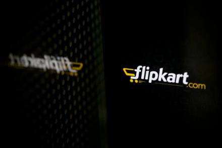 Flipkart's application loading page, displayed on an Apple Inc. iPhone 5c, is reflected on a window in an arranged photograph in Hong Kong, China, on Wednesday, May 21, 2014. Flipkart, India's largest online retailer, will buy competitor Myntra.com, according to people with knowledge of the talks, to gain a business with higher margins and strengthen its position in the local market against Amazon.com Inc. Photographer: Brent Lewin/Bloomberg