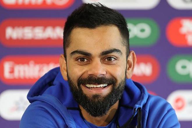 captain Virat Kohli smiles as he responds to a question during a press conference ahead of their Cricket World Cup semifinal match against New Zealand at Old Trafford in Manchester (AP Photo)