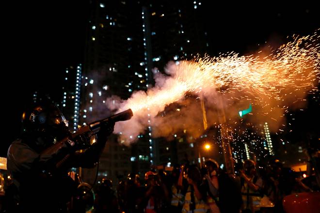 Riot police fire tear gas to disperse anti-extradition bill protesters after a march to demand democracy and political reforms, at Wong Tai Sin in Hong Kong