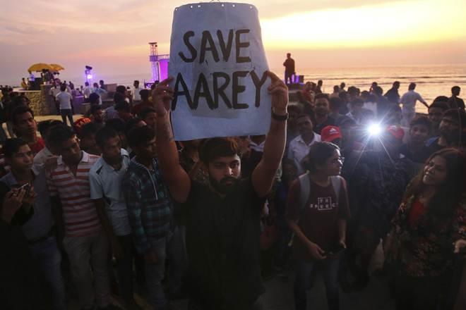 An activist holds a placard during a protest against cutting down of trees for a proposed metro car shed project at Aarey Colony in Mumbai. (AP Photo)