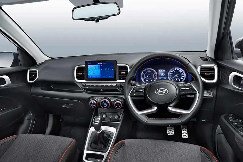 The cabin of the Hyundai Venue Sport has been reworked as well. It features a new Sport Dual Tone trim set up with denim-like fabric seats and red piping and stitching. The dash also features red accents to complement the exterior. The HVAC knobs, the ac vents and the stitching of the leather-wrapped steering wheel in red add to the sporty flavour that Hyundai is going for. Additionally, the Venue now gets a new multi-function flat-bottom steering wheel which matches the design in its latest generation models like the new Creta.
