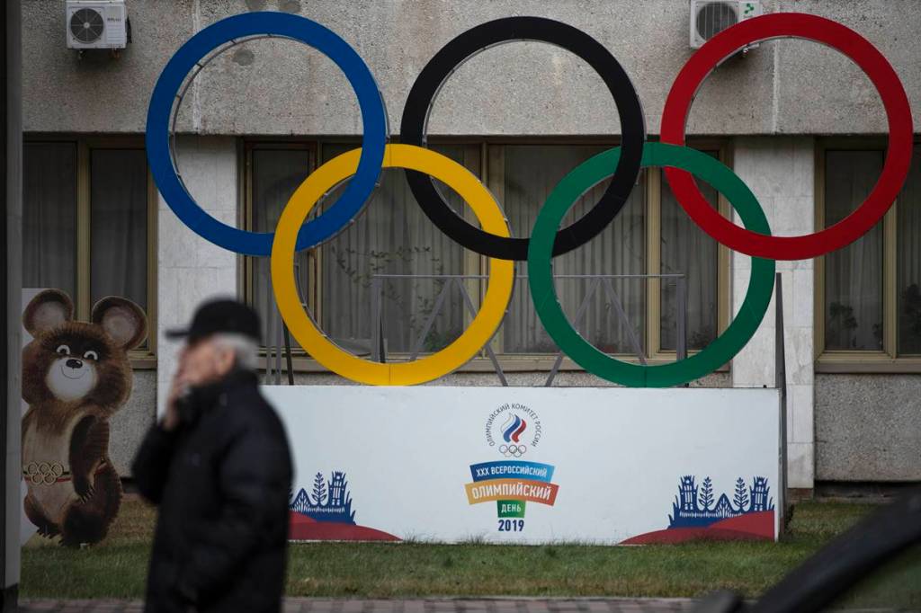 Olympic Rings and a model of Misha the Bear Cub, the mascot of the Moscow 1980 Olympic Games are seen in the yard of Russian Olympic Committee building in Moscow, Russia. (AP Photo/file)