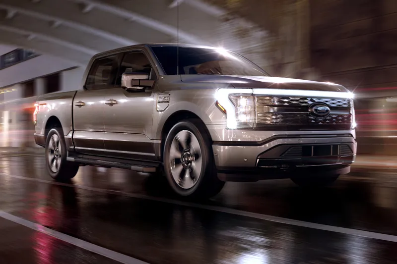 Ford has finally taken the covers off of the all-electric vision of the best selling vehicle in America. Welcome, the Ford F-150 Lightning that is aimed squarely at Rivian R1T and Tesla Cybertruck. Ford has priced the F-150 Lightning at a jaw-dropping USD $41,699 (Rs 30.5 lakh) for the base model. At that price, Ford is trying to prove you don’t need to dump your life savings to buy an EV. The Lightning will go on sale in 2022.