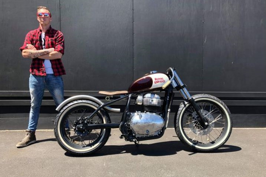 Custom Royal Enfield Interceptor 650 Bobber with unique exhaust swooping over rear wheel