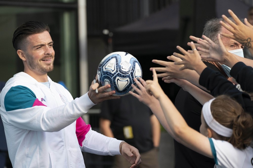 Manchester City's new signing Jack Grealish hands a football to supporters (PTI IMage)