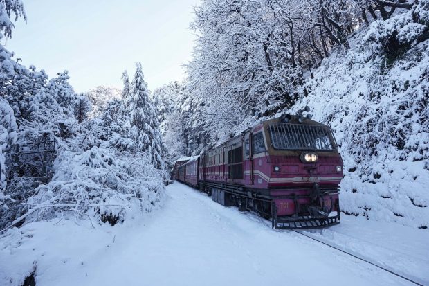 A toy train runs on Kalka-Shimla heritage rail track covered in snow after heavy snowfall in Shimla. (PTI Photo)