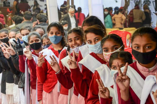 Students flash the victory sign as they wait to receive a dose of COVID-19 vaccine at Civil Hospital, in Amritsar. (PTI Photo)