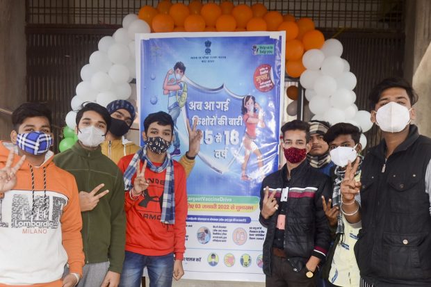 Students flash the victory sign after receiving a dose of COVID-19 vaccine in Mirzapur. (PTI Photo)