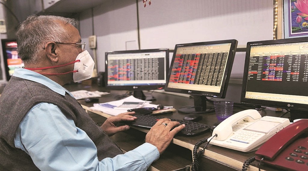 A stock broker at Northern Stock Exchange wearing mask due to Corona Virus threat in Sector 17 Chandigarh on Tuesday, March 17 2020. Express photo by Jaipal Singh