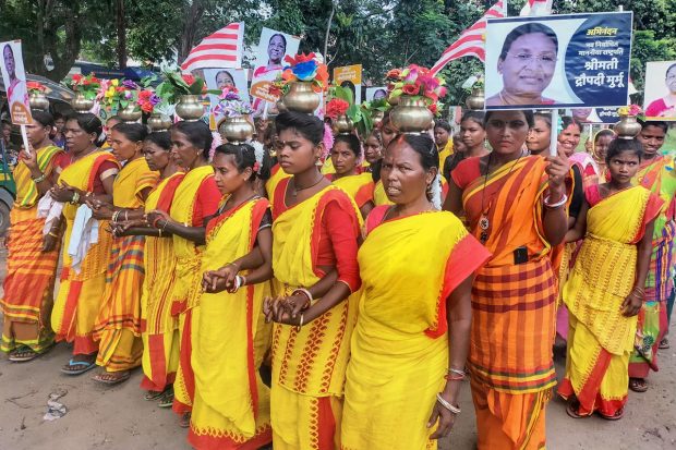 People belonging to tribal community dance in support of Droupadi Murmu in Dhanbad. (PTI Photo)