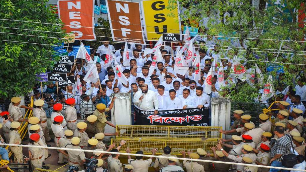 Police personnel stand guard as North-East Students Organisation (NESO) leaders and activists stage a protest demanding scrapping of Citizenship Amendment Act (CAA), in Guwahati, Wednesday. (PTI Photo)