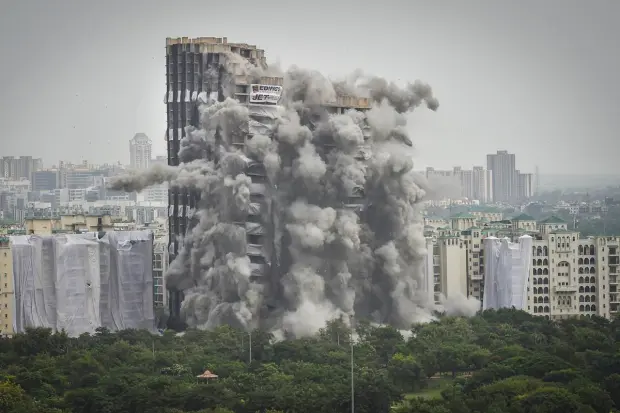 Dust covers the area after demolition of Supertech's twin towers in Noida. (PTI Photo)