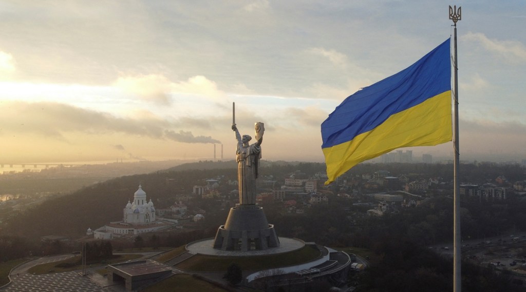 Ukraine's biggest national flag on the country's highest flagpole and the giant 'Motherland' monument are seen at a compound of the World War II museum in Kyiv, Ukraine, December 16, 2021. Picture taken with a drone. REUTERS/Valentyn Ogirenko