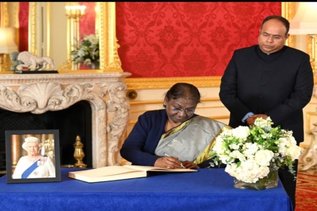 The President of India, Droupadi Murmu and Acting High Commissioner Sujit Ghosh signs a book of condolences at Lancaster House following the death of Queen Elizabeth II, in London, Sunday, Sept. 18, 2022. (AP)