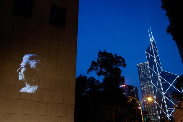An image of Britain's Queen Elizabeth is projected outside the British Consulate-General, following queen's death, in Hong Kong. REUTERS