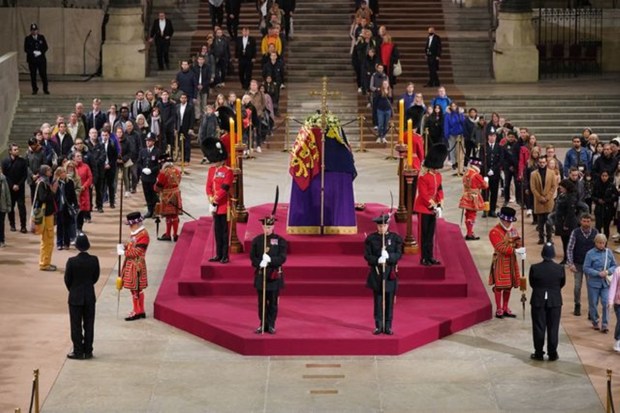 At 4.57am on the day of her funeral the final members of the public pay their respects at the coffin of Queen Elizabeth II, draped in the Royal Standard with the Imperial State Crown and the Sovereign's orb and sceptre, lying in state on the catafalque in Westminster Hall, at the Palace of Westminster, London. REUTERS
