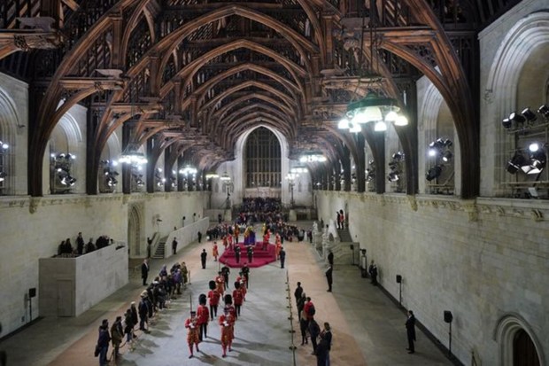 At 06:02am on the day of her funeral the final members of the public pay their respects at the coffin of Queen Elizabeth II, draped in the Royal Standard with the Imperial State Crown and the Sovereign's orb and sceptre, lying in state on the catafalque in Westminster Hall, at the Palace of Westminster, London. REUTERS