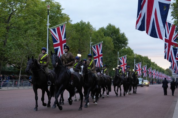 People ride horses on The Mall on the day of the state funeral and burial of Britain's Queen Elizabeth, in London, Britain. REUTERS