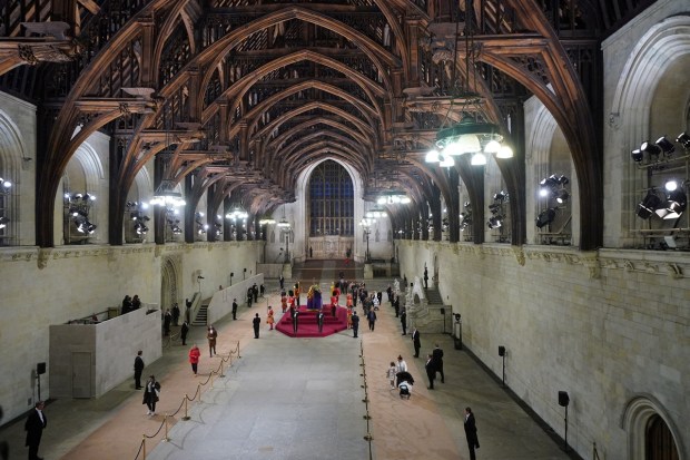At 06:26am on the day of her funeral the final members of the public pay their respects at the coffin of Queen Elizabeth II, draped in the Royal Standard with the Imperial State Crown and the Sovereign's orb and sceptre, lying in state on the catafalque in Westminster Hall, at the Palace of Westminster, London. REUTERS