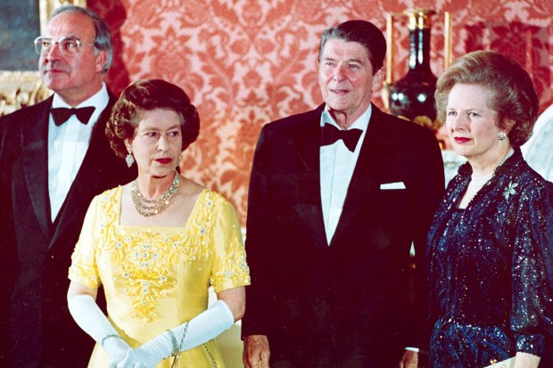 Queen Elizabeth II, second left, stands with, West German Chancellor Helmut Kohl, left, U.S. President Ronald Reagan, second right, and Britain's Prime Minister Margaret Thatcher at London's Buckingham Palace, prior to a dinner with summit leaders June 10, 1984. (AP Photo)