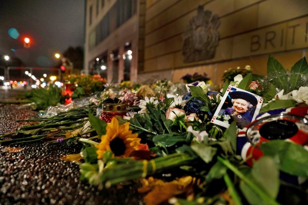 Flowers and a photo lie in front of the British Embassy as a sign of mourning after the death of the British Queen Elizabeth II, in Berlin Monday, Sept. 19, 2022. The funeral of Queen Elizabeth II, Britain's longest-reigning monarch takes place on Monday. AP