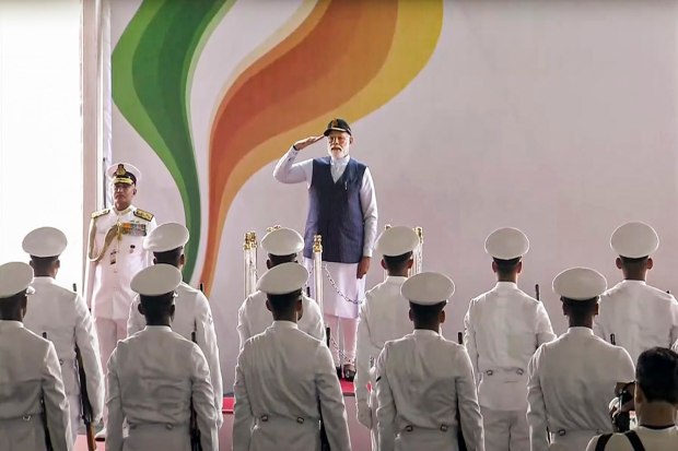 Kochi: Prime Minister Narendra Modi unveils the Indian Navy’s new ensign during the commissioning ceremony. Kerala Governor Arif Mohammad Khan and CM Pinarayi Vijayan (PTI Photo)