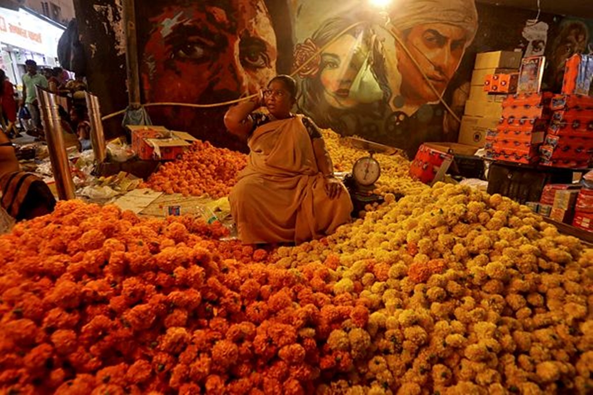 A woman selling flowers waits for customers at a market place ahead of the Hindu festival of Diwali in Mumbai, India. (REUTERS photo/Niharika Kulkarni)