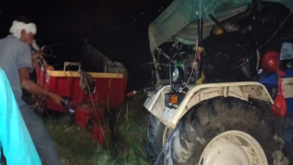 A tractor-trolley overturned and fell into a pond near a village in Kanpur district, Saturday night. (PTI Photo)