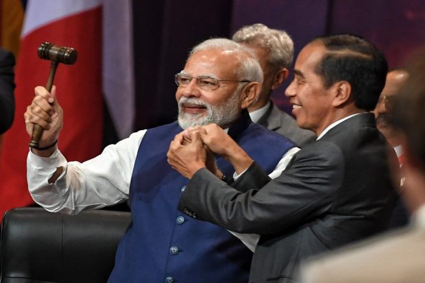 India takes charge of G20. Indonesian President Joko Widodo symbolically handed over the G20 Presidency to PM Narendra Modi. (Photo: Twitter/MEA)