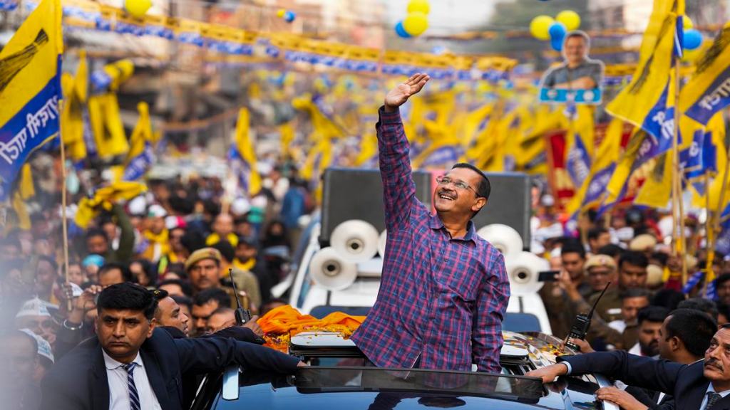 AAP National Convenor and Delhi Chief Minister Arvind Kejriwal waves during a roadshow for MCD elections at Malka Ganj in New Delhi, Wednesday, Nov. 30, 2022. (PTI Photo)
