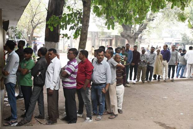 Vadodara: Voters waiting in a queue to cast their votes during the second phase of Gujarat assembly elections, in Vadodara on Monday. (PTI Photo)
