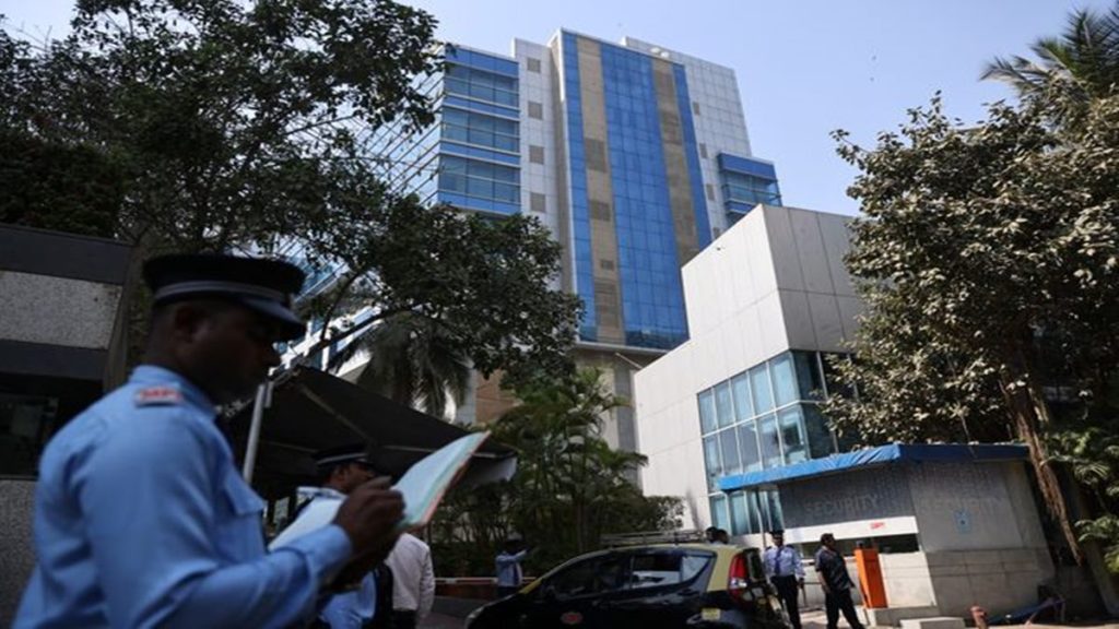 A private security guard stands outside a building with BBC offices, where income tax officials are conducting a search, in Mumbai, India, February 14, 2023. REUTERS/Francis Mascarenhas.