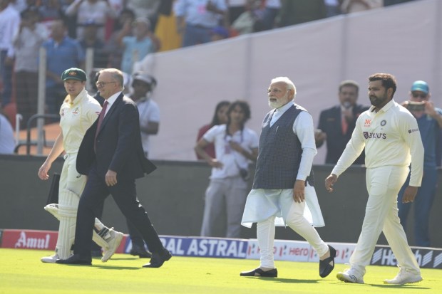 The round of the playing turf on a golf car by the two dignitaries was applauded by the thousands of spectators who had already taken their seats in the world's largest cricket stadium. (AP photo)