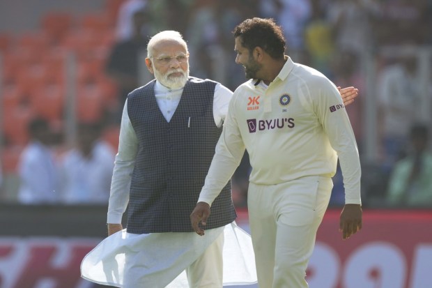 Prime Minister Narendra Modi pats on the back of Indian cricket team captain Rohit Sharma. (AP photo)