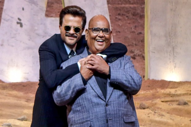 Bollywood actors Satish Kaushik and Anil Kapoor during an event in Mumbai. (PTI photo)